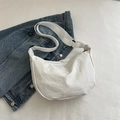 White minimalist half-moon crossbody bag with textured fabric and wide adjustable strap - White