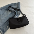 Minimalist black shoulder bag with adjustable strap and decorative resin chain detail - Black