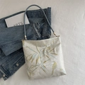 Oriental style tote bag with gold bamboo embroidery and blue shoulder straps on white desk - Bamboo Leaf