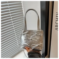 Detailed view of silver metallic bucket bag with 3D bows and spherical chain strap - Silver