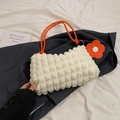 Chic cream bubble-textured hobo bag with bright orange rope handle and floral charm - White and Orange
