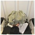 Detail of light green bucket bag with metallic butterfly charm and silver chain strap - Green