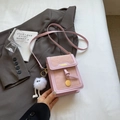 Schicke rosa Crossbody-Handytasche mit goldenem Anhänger und weißem Plüsch-Anhänger - Rosa