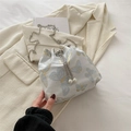 White bucket bag with blue butterfly print, pearl drawstring, and silver chain strap - Butterfly