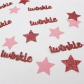 Macro shot of pink paper stars and red glitter twinkle confetti for party table decor - Rose Gold With Rose Gold Pink Stars