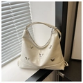 Detail of cream hobo bag featuring silver butterfly studs and croc-embossed texture - White