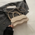 Creamy textured crossbody bag with wavy edges and woven flap for stylish daily wear - Khaki