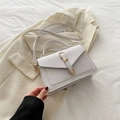 Chic white textured leather crossbody square bag with gold buckle on beige blazer - White