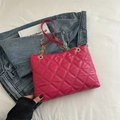 Quilted rose red tote bag with gold chain strap on denim fabric background - Rose Pink