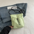 Minimalistische mintgroene crossbody tas met trekkoord en zwarte schouderband - Groen