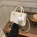 Minimalist white corduroy crossbody square bag with plush ball charm on wooden table - White With Pendant