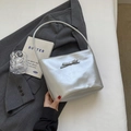 Chic silver leather hobo bag with bow detail on a grey blazer background - Silver