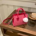 Rose pink corduroy tote bag with plush ball charm and gold hardware on a wooden table - With Ornament / Rose Pink