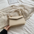 Chic cream woven crossbody bag with knotted handle detail and trapezoid flap design - White