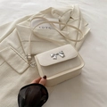 Elegant cream white square crossbody bag featuring a silver metal butterfly bow accent - White