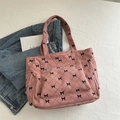 Bolso tote de pana rosa con estampado de lazos negros y bolsillo frontal con cremallera - Rosa