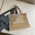 Beige mesh beach tote bag in semi-transparent nylon with white THE BEACH BAG text - Khaki With White Text