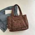 Bolso tote de pana marrón con estampado de lazos y bolsillo frontal elegante - Marrón
