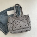 Gray corduroy tote bag with black bow prints and quilted diamond pattern detail - Gray