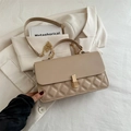 Beige quilted crossbody bag with gold chain strap and metal lock shown on white fabric - Khaki