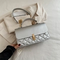 Silver quilted crossbody bag with golden rectangular lock and chain strap detail - Silver