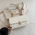 Chic beige quilted crossbody bag with golden chain strap and textured leather finish - White