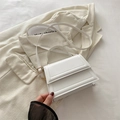 Minimalist white trapezoid handbag with quilted edges and gold-tone metal hardware - White