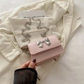 Piccola borsa rosa a tracolla con fiocco in metallo argento e catena argentata - Rosa