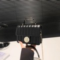 Chic black quilted crossbody bag with golden chain and circular twist lock detail - Black