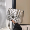 Chic silver quilted chain bag with metallic finish and vertical twist lock shown held - Silver