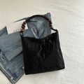 Black pleated shoulder bag featuring elegant dark brown wooden beaded handles for women - Black