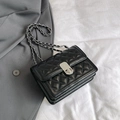 Black quilted crossbody bag with silver chain strap and metal clasp closure - Black