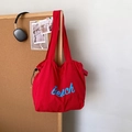 Red drawstring tote bag with Beach lettering and shoulder strap for casual use - Red
