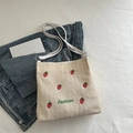 Beige strooien tas met aardbeien borduursel en witte handvatten voor de zomerse strand - Broken Wit