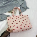Pink corduroy tote bag featuring a cute strawberry print and soft shoulder handles - Pink