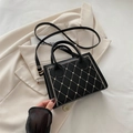 Chic black crossbody bag with heart embroidery and golden hardware on a blazer - Black