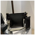 Close-up of black glossy leather bucket bag with bohemian patterned wide shoulder strap - Black