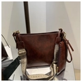 Close-up of chocolate brown tote with herringbone wide strap and gold hardware - Coffee