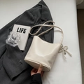Schicke beige Eimer-Handtasche aus Leder mit Perlenbogen-Herzanhänger und Schultergurt - Mit Anhänger / Gebrochenes Weiß