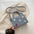 Stylish blue denim mini handbag featuring colorful heart decor and a shoulder strap - Blue