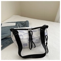 Detail of a pleated nylon bag featuring purple ink landscape print and black drawstring - Purple