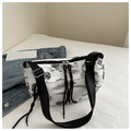 Macro detail of ink-print pleated crescent bag showing toile de jouy pattern and double zipper - Black