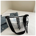 Detail of white pleated shoulder bag featuring blue landscape patterns and black straps - Blue