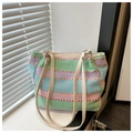 Detail of colorful striped woven tote bag featuring cream leather strap and metal ring - Green