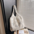 Off-white canvas tote bag featuring blue butterfly patterns and frayed fringe texture - Gray