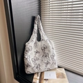 White fuzzy canvas tote bag with black butterfly patterns and soft plush texture - Black