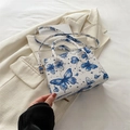 White leather handbag with blue butterfly prints and celestial patterns on blazer - Blue