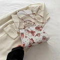 Square white PU leather handbag featuring red butterfly prints and adjustable gold hardware strap - Red