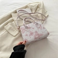 White mini handbag with pink butterfly print and adjustable strap on a blazer background - Pink