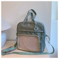 Detail of sage green canvas tote with mesh pocket and dual strap versatile design - Green